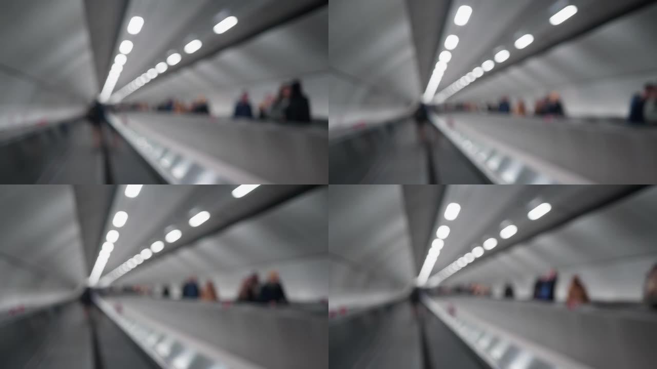 地铁里模糊的自动扶梯和无法辨认的人。与松下GH5一起拍摄