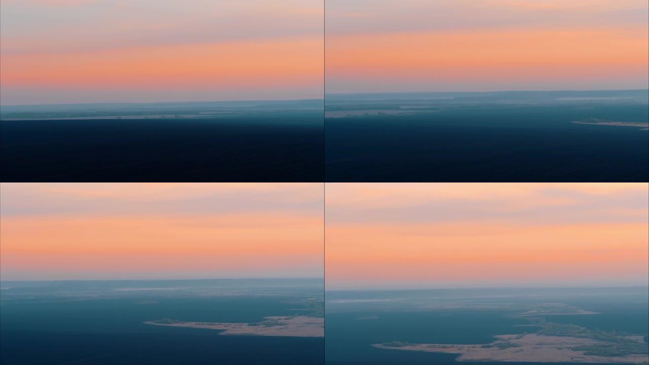 黑山谷上空的粉红色日落。柔和的天空色调，美丽的天空。来自地面直升机的全景。天空中的雾。4K。