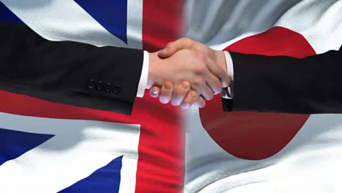 英国和日本握手，国际友谊，旗帜背景