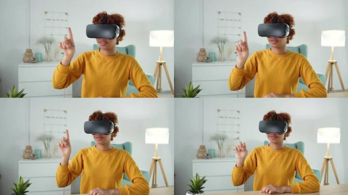 非裔美国年轻女子在家中佩戴使用虚拟现实metaverse VR眼镜耳机。女孩在虚拟现实头盔上的虚拟现
