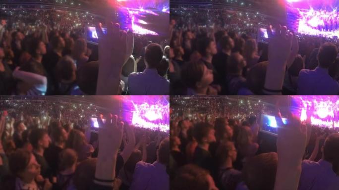 手持智能手机在体育场拍摄摇滚音乐会的特写镜头