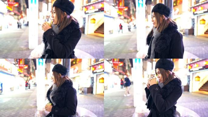 日本大阪市道顿堀街夜市坐着喝茶的美女游客
