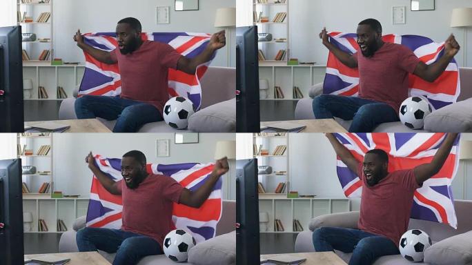 英国球迷挥舞旗帜为国家队加油，在家观看比赛