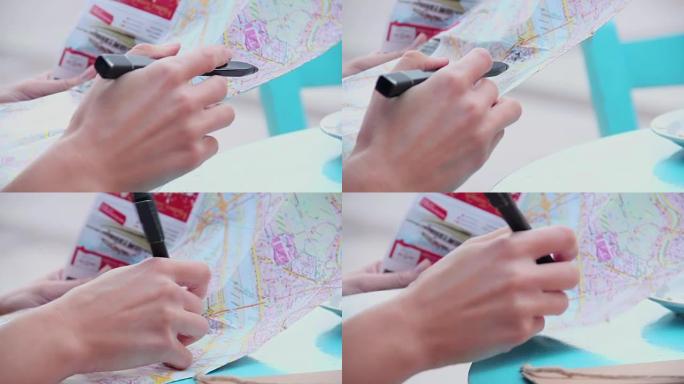女性手握地图特写，写笔记，检查路线