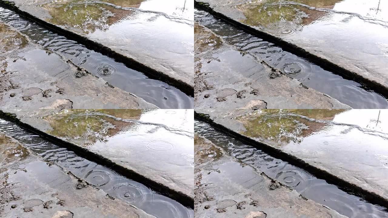 下雨时，水泥沟向河水流动