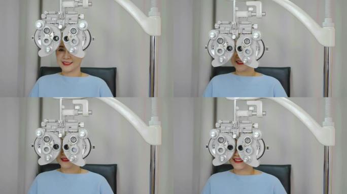 微笑的亚洲高级女性在光学验光仪上做眼部检查，在诊所或眼镜店用验光机检查她的眼睛，眼科概念。