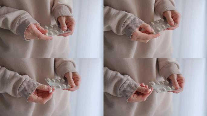 用一堆药片近距离拍摄双手。女人从一只手向另一只手撒药，慢动作射击