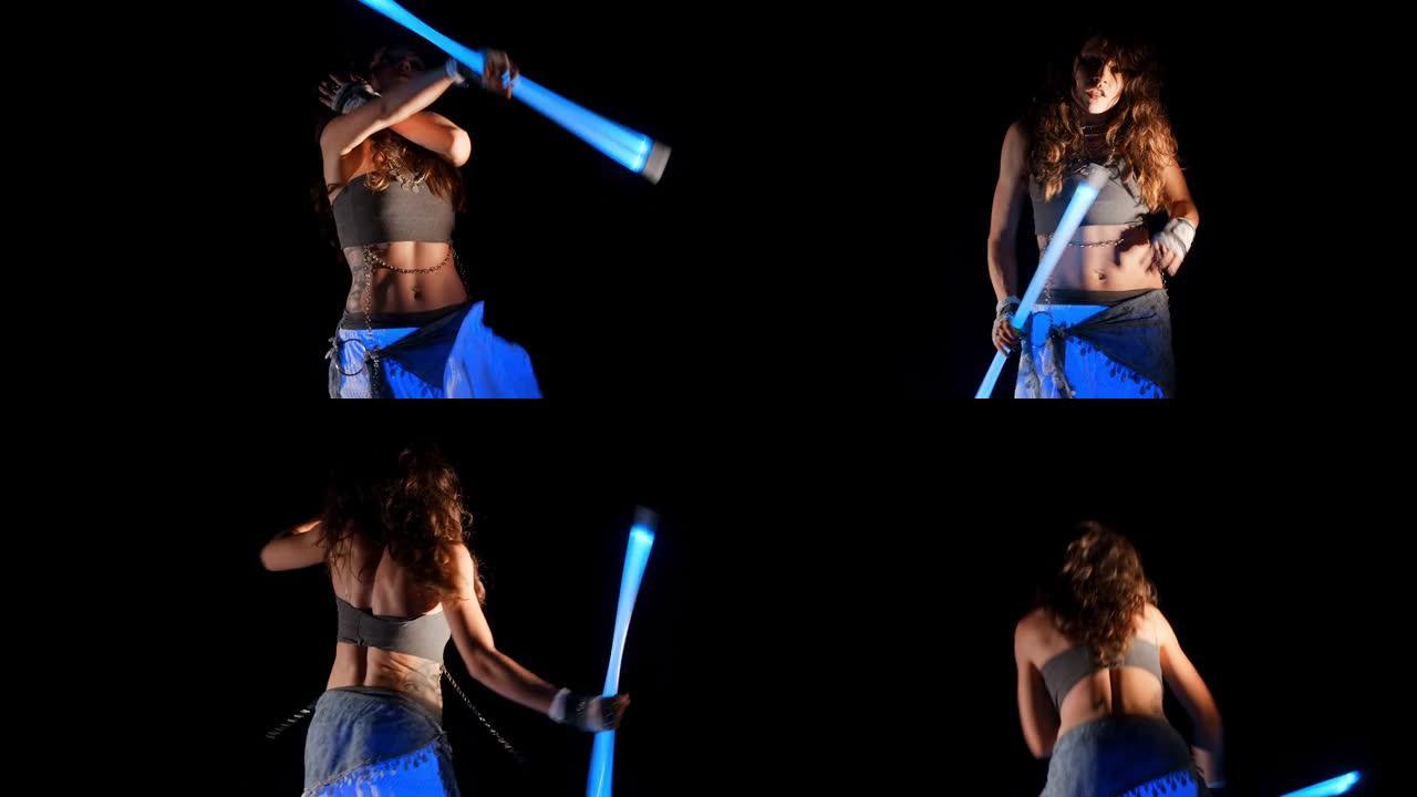 吉普赛黑发女人在紫外线下与霓虹灯舞动，舞蹈表演