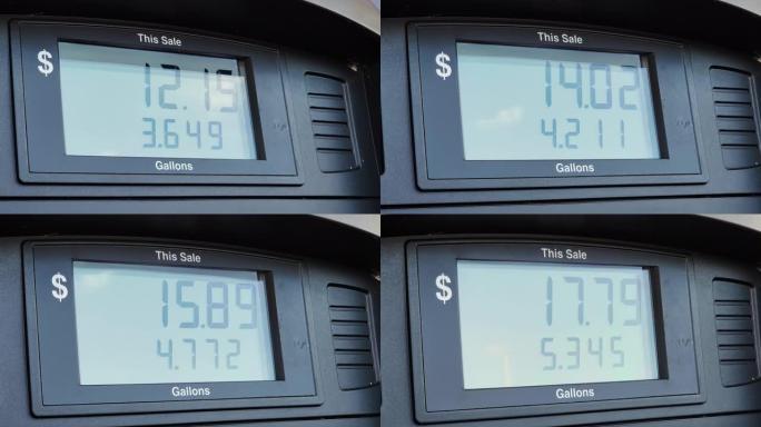 加油站的一个汽油泵的特写镜头显示，为泵送的加仑燃料支付了美元。屏幕显示加满汽车油箱的总成本。高油价