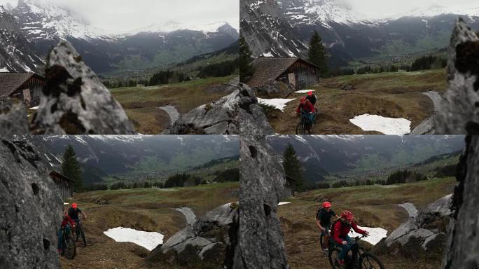 成熟的夫妇骑山地电动自行车穿越困难的山区地形