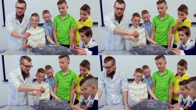 实验室助理向男孩展示了在chladni盘子上跳舞的沙子