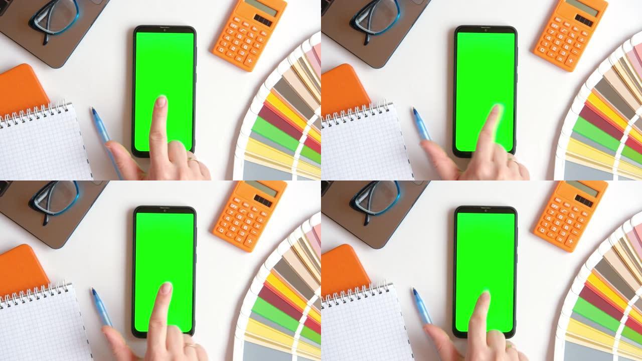 女性用chromakey屏幕在手机上触摸、点击、滑动。缩小。特写手势包。女孩使用智能手机绿屏模拟显示