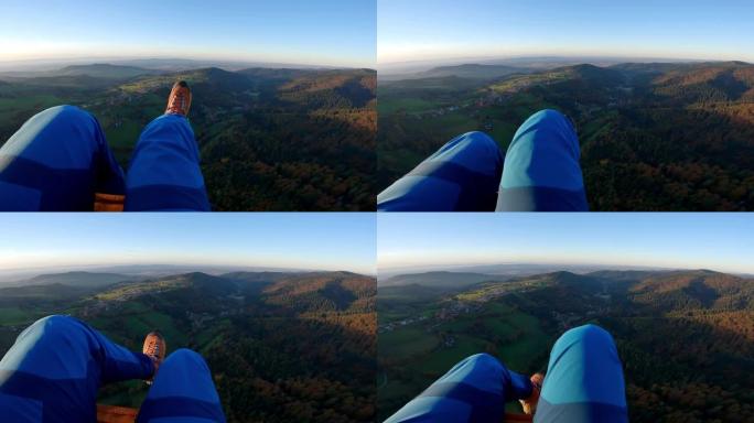 滑翔伞飞越森林山丘的前视图