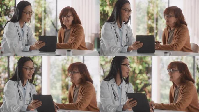 女医师在健康诊所咨询期间与一名高级妇女交谈，并在平板电脑上显示她的x射线扫描。穿着白大褂的亚洲护士建