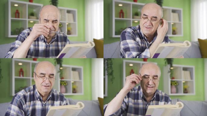 患有眼疾的老人在看书时戴眼镜。