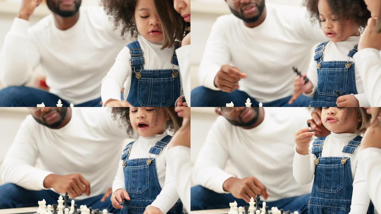 多种族新手父母与女儿在客厅下棋的特写镜头。