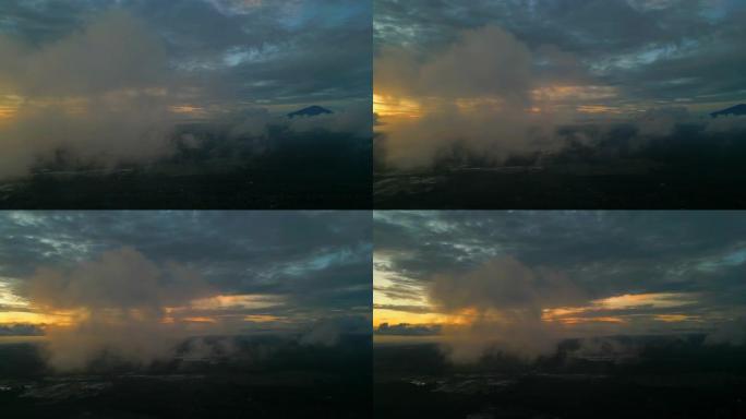 在印度尼西亚白族的金色日落期间，一座火山的云层的无人机镜头