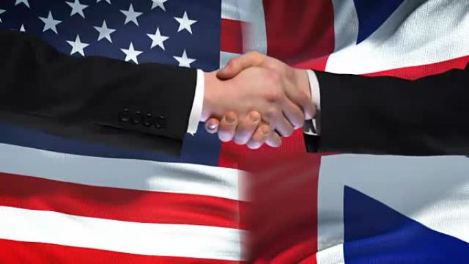 美国和英国握手，国际友谊旗帜背景