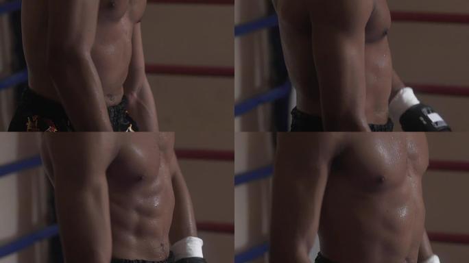 大汗淋漓的拳击手在拳击赛前热身肌肉