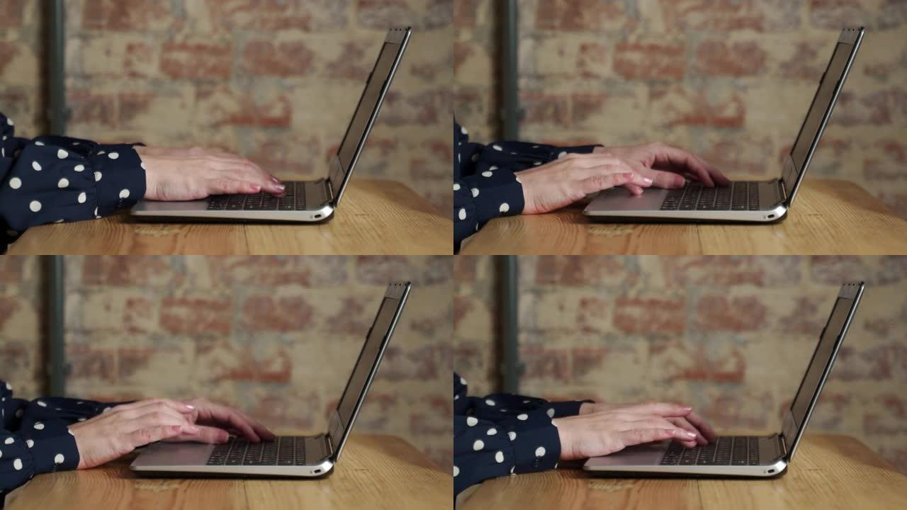 在办公室使用笔记本电脑的女性手的特写镜头，在内部的笔记本电脑键盘上打字的女性手，使用笔记本电脑的商人