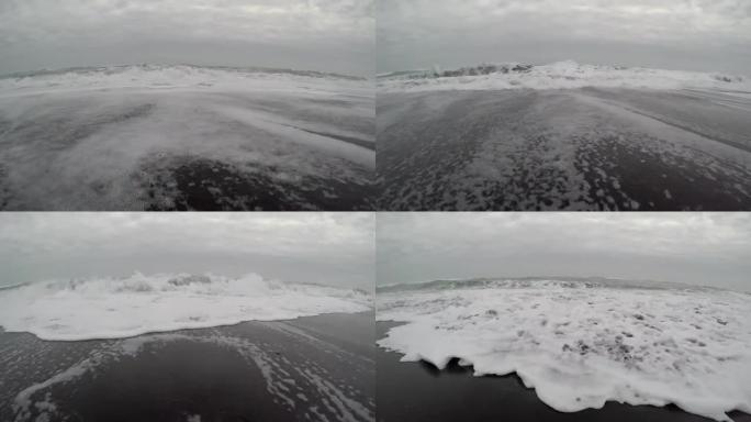 海浪在黑沙滩上坠毁