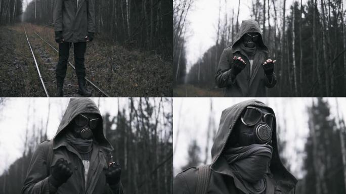 核灾难后，戴着防毒面具的流浪者站在森林的铁路上