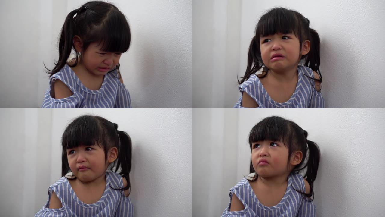 一个乱扔垃圾的亚洲女孩坐在康纳房间里，在被停电惩罚后哭泣。