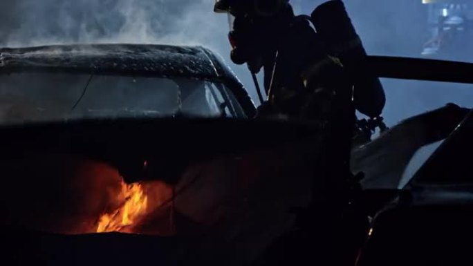 消防员夜间在车祸现场用消防泡沫扑灭汽车大火