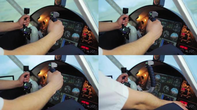 男性飞行员的手转动方向盘，驾驶舱面板上的切换控件