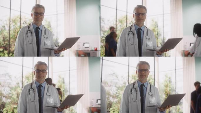一位经验丰富的中年英俊医生穿着白大褂，在诊所里拿着一台笔记本电脑的肖像。成人医疗保健专业人员看着镜头