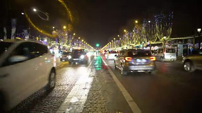 许多汽车在夜间城市道路上行驶，树木装饰着明亮的闪闪发光的灯光