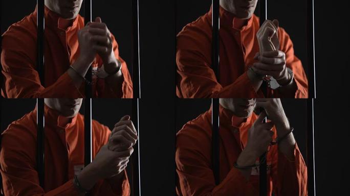 囚犯在监狱里戴着手铐摩擦手腕，不人道的条件和酷刑