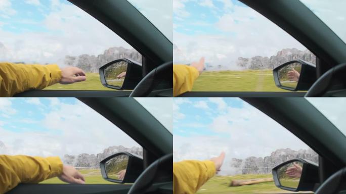 男子开车时将手伸出窗外以赶上风