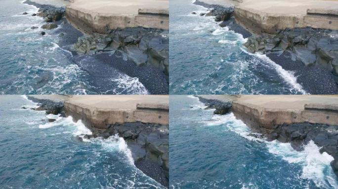 岛屿或大陆的混凝土海岸。防止海啸和大浪。海浪或海浪撞击海岸和岩石