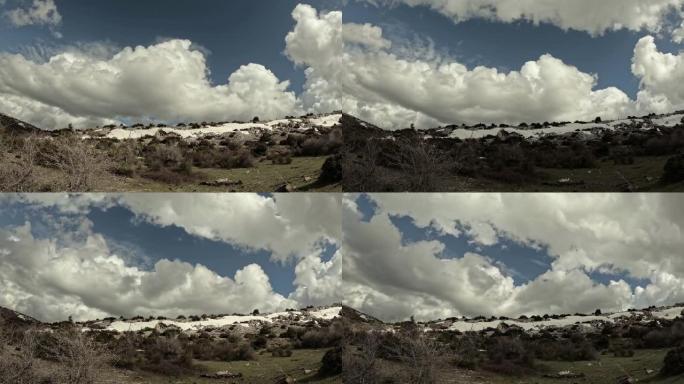 延时视频显示云层在积雪覆盖的岩石山上掠过。