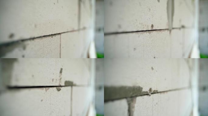 加气混凝土砖墙的接缝特写。摄像机沿气块砌体的平滑运动