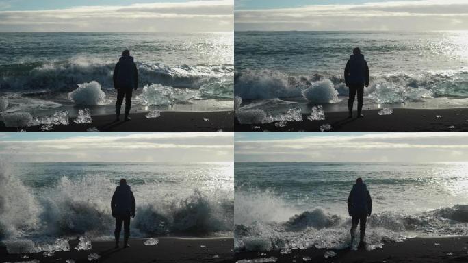 一名男子面对钻石海滩的海浪