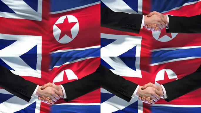 英国和朝鲜握手国际友谊旗帜背景