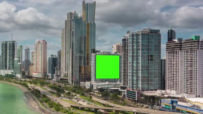 城市摩天大楼上的绿屏广告牌