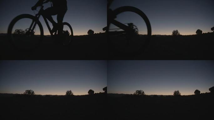 日落时骑自行车的人的剪影