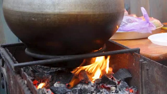 在巨大的大锅中沸腾的食物着火，传统的露天烹饪