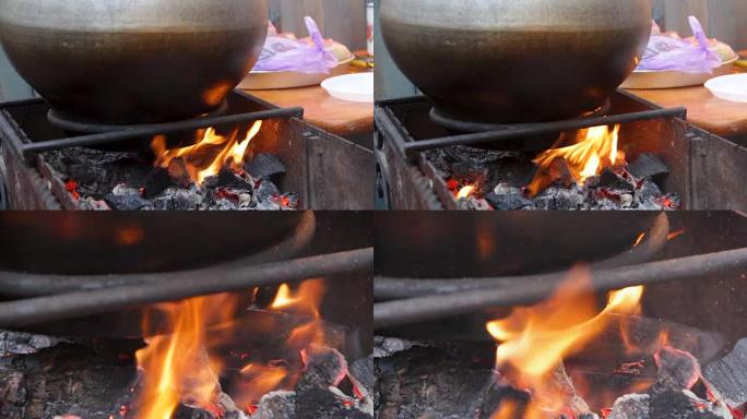 在巨大的大锅中沸腾的食物着火，传统的露天烹饪