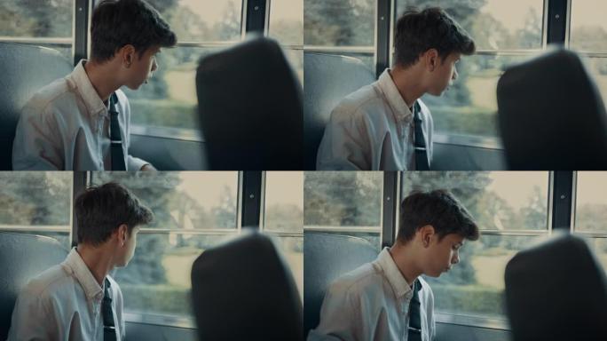 印度少年坐在公共汽车上近距离观察。男孩看着车窗。