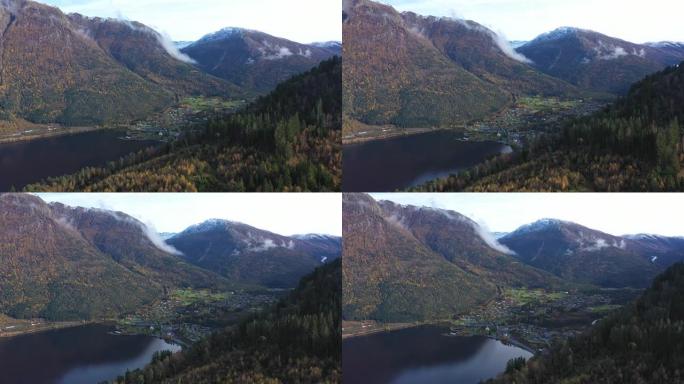 空中飞越山坡，揭示挪威乌伦斯旺史诗般的环境中的金萨尔维克镇 -- 在阳光明媚的秋天早晨，具有视差效应