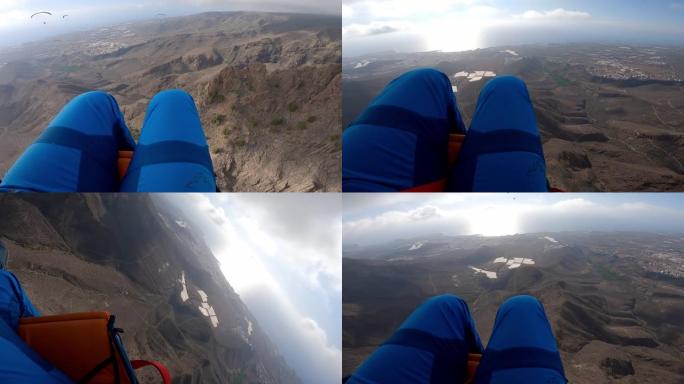 滑翔伞在崎rock的岩石地形上飞行的前视图