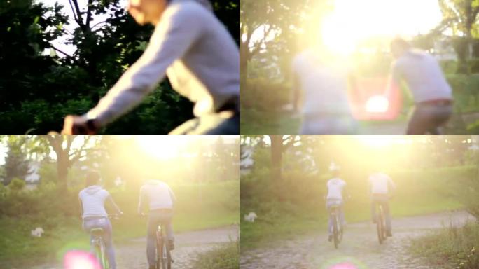 年轻的成年夫妇骑自行车，男人微笑的女人浪漫