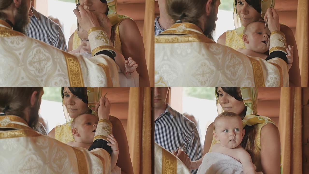 牧师在婴儿洗礼期间用油涂油的仪式