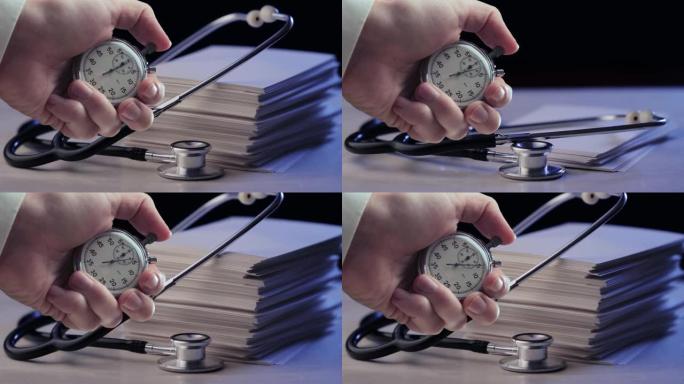 听诊器的镜头，手里拿着一叠卡片和秒表