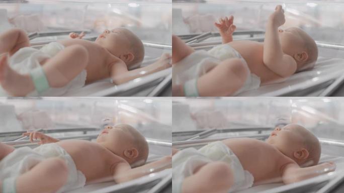 可爱的情感新生婴儿躺在医院的婴儿床。有趣的打哈欠的高加索婴儿花时间在产科诊所，准备睡觉。医疗保健、怀