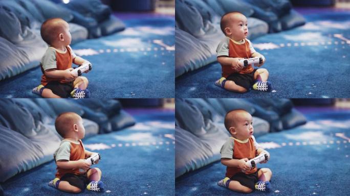 可爱的男婴使用游戏控制器在客厅玩视频游戏